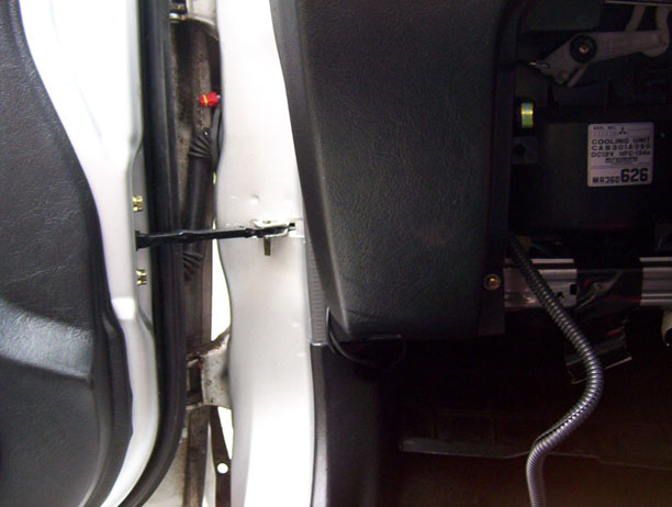 The electronic cables being fed through the glove-box and then through the grommet